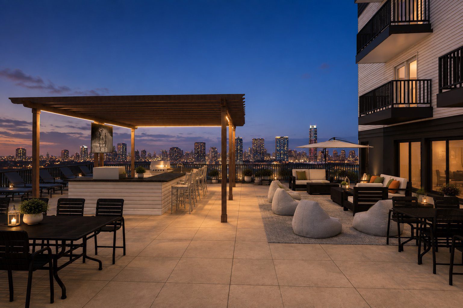 Rooftop deck at dusk with fire tables, pergola, and the Minneapolis skyline