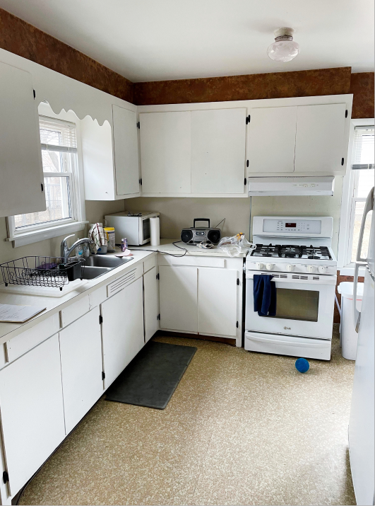 Original kitchen with white cabinets and faux finish wall border
