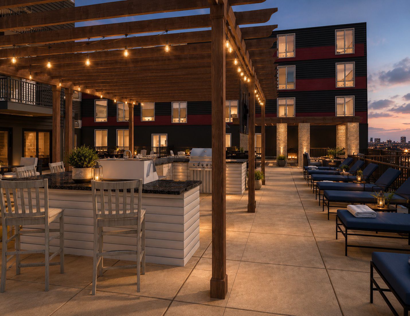 Outdoor kitchen and bar under a louvered pergola with festoon lighting