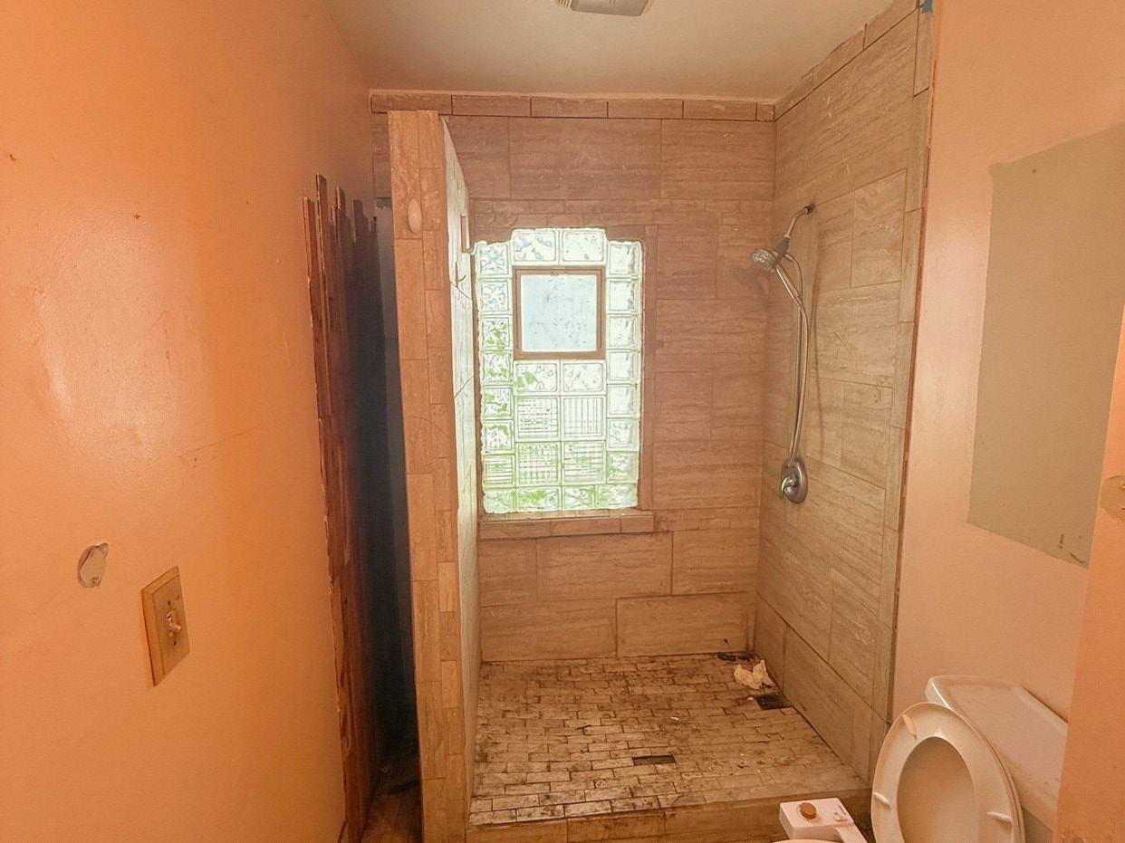 Bathroom before remodel, stripped to bare walls