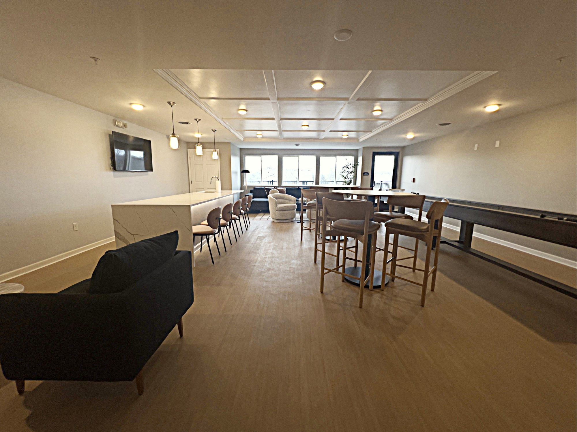 Clubhouse lounge with shuffleboard and bar seating