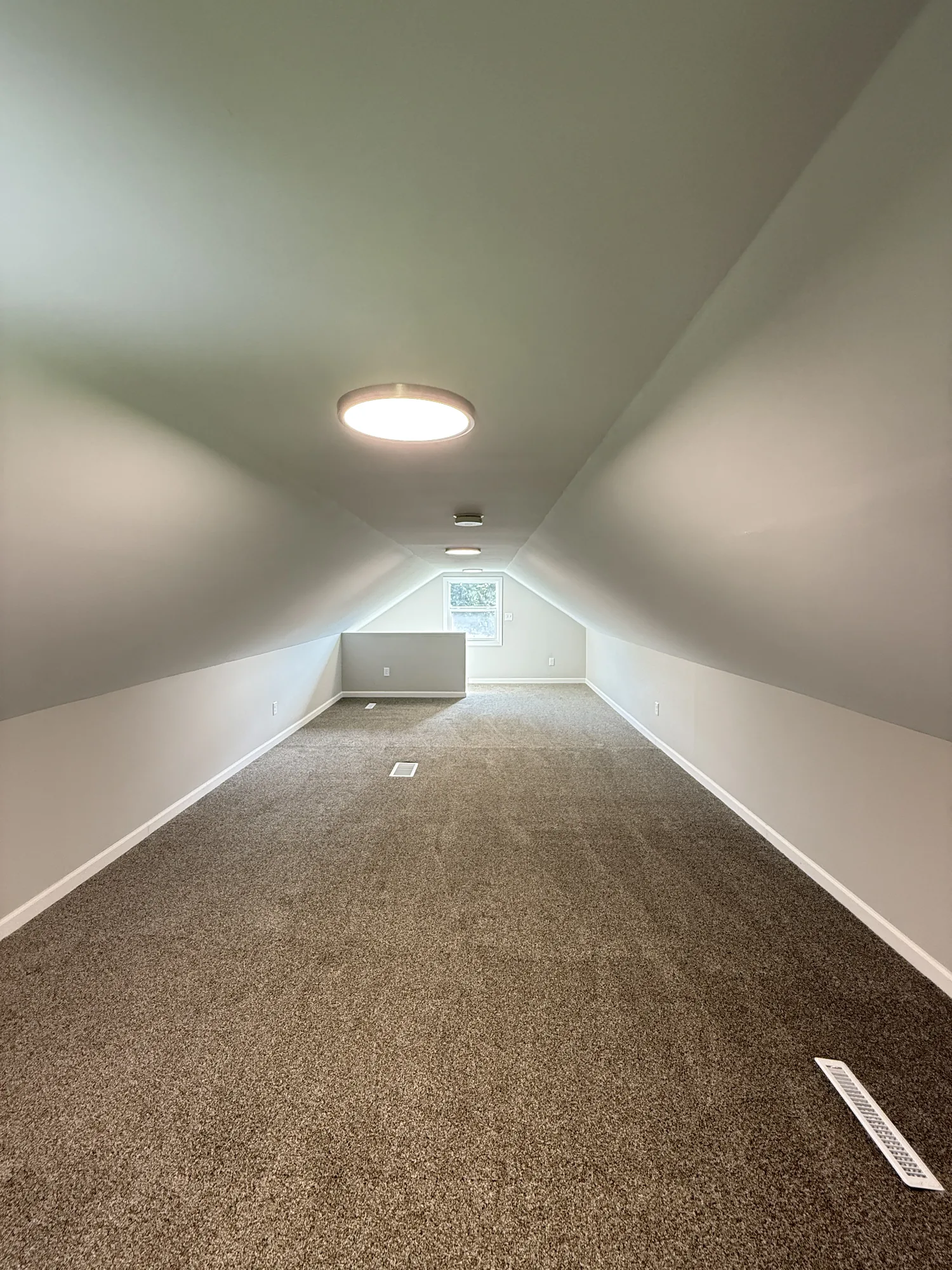 Fully finished attic bedroom with new carpet, smooth painted ceilings, recessed lighting, and clean trim