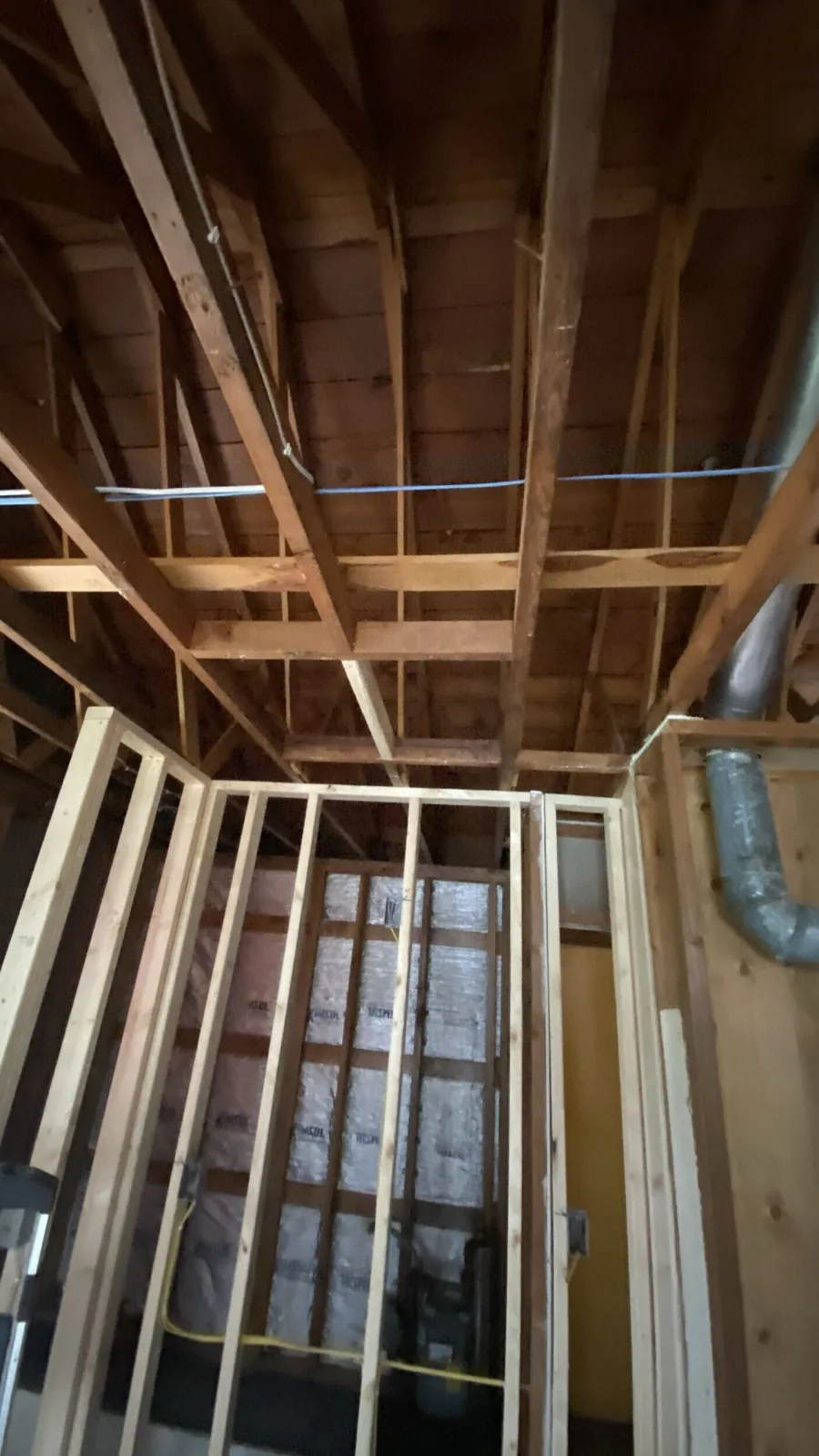 Before: ceiling and roof framing exposed after demolition