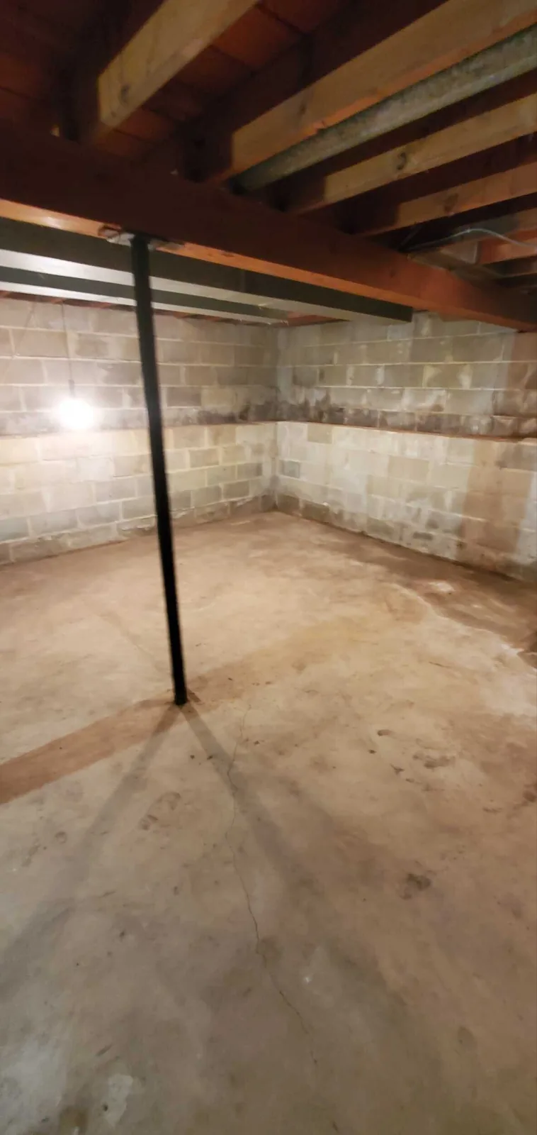 Before: structural beam and bare subfloor mid-rebuild