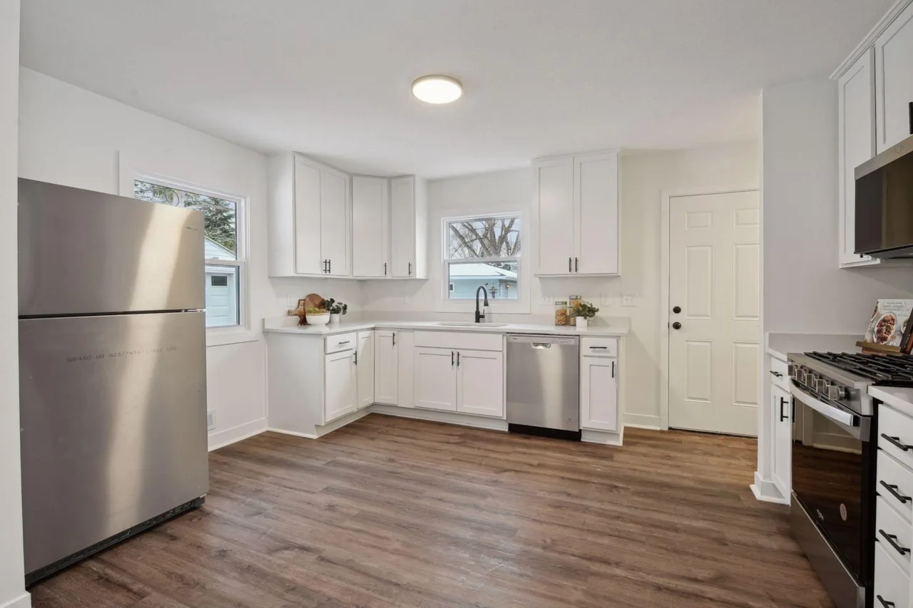New kitchen with white cabinetry and stainless appliances