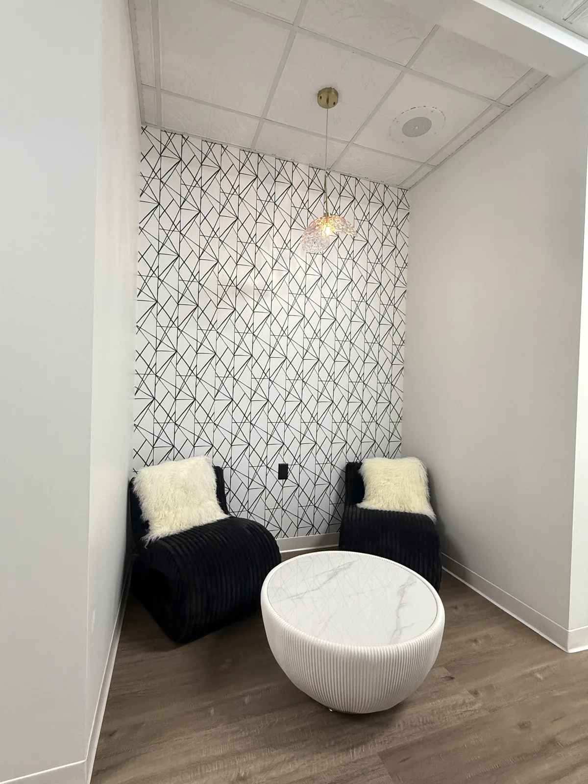 Waiting nook with tiled feature wall and soft seating