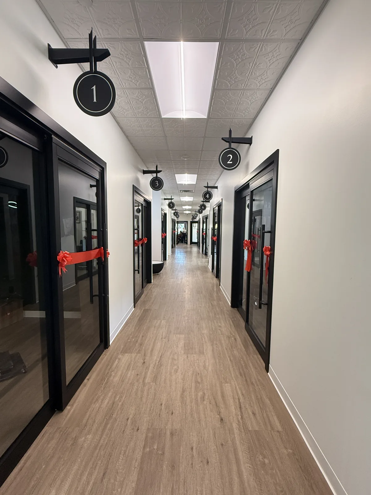 Numbered studio suite doors along a finished corridor